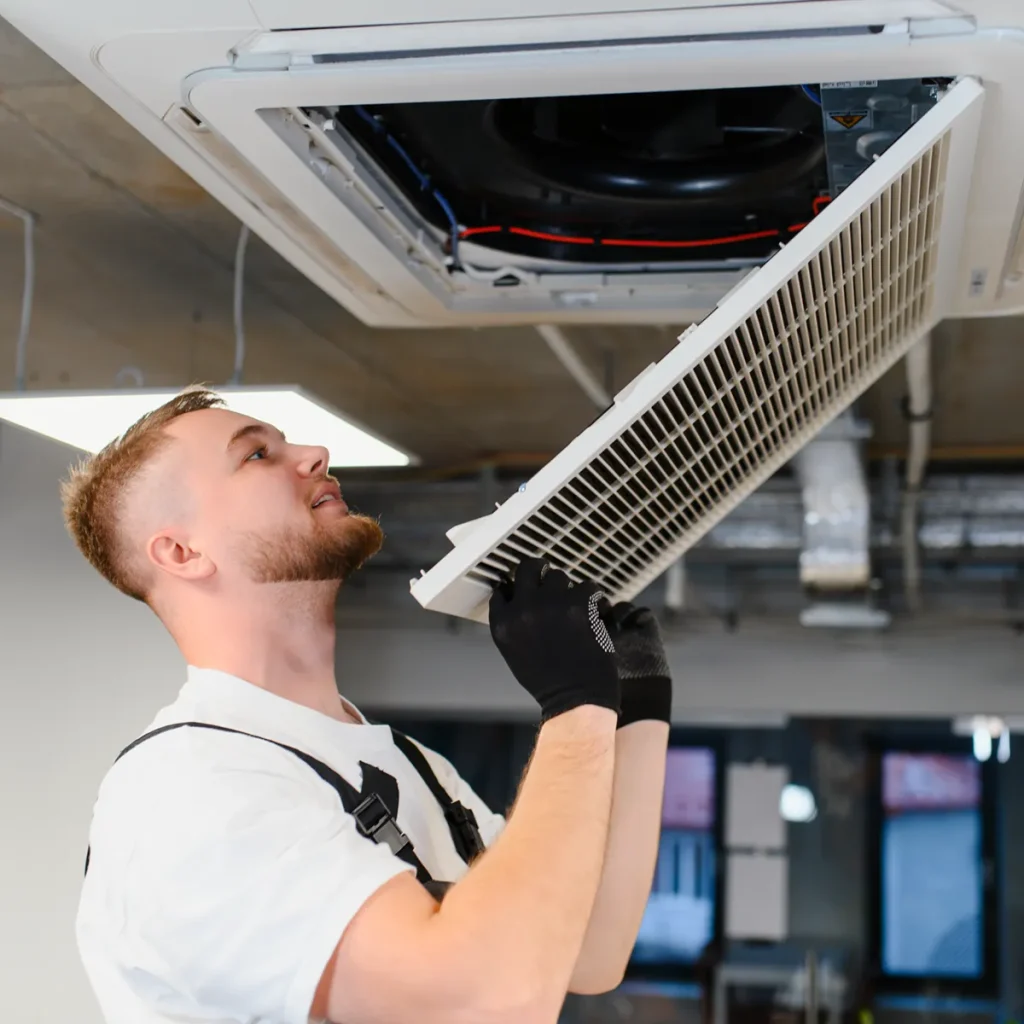 hvac technician removing air conditioning filter